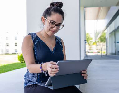 female student working on a laptop