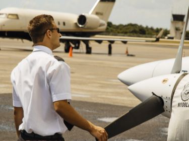 A pilot stands next to a plane