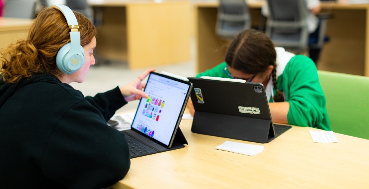 Students use tablets in the school library as part of their education.
